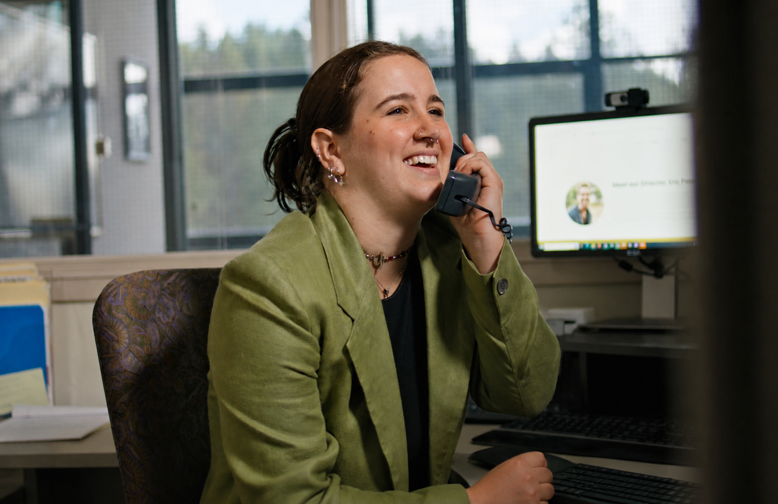 Business student speaking on the phone at a desk