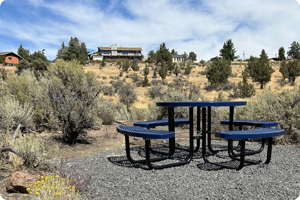 Picnic table on Madras Campus with views of the cascading landscape