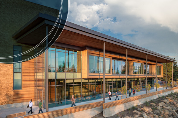Exterior shot of Middleton Science Center with students walking on the outside patio as the sun sets COCC Campus