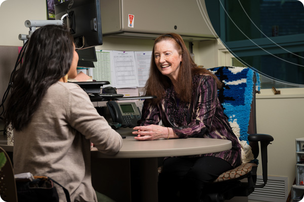 Academic Advisor smiling at their advisee