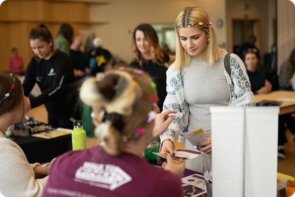 Student reading a job application at COCC JobFest