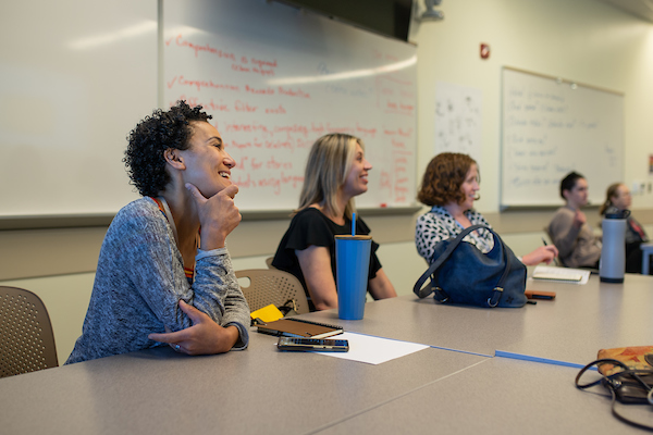 Students taking notes while listening to an instructor