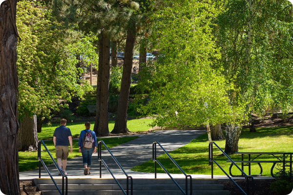 COCC students walking through the trees on Bend Campus