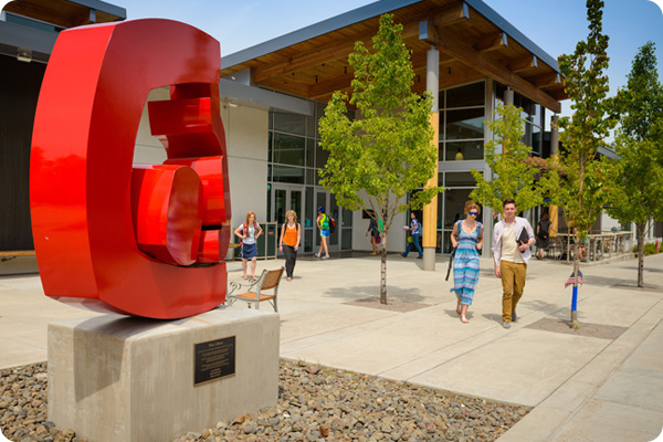 red statue in front of Coats Campus Center with students walking to class