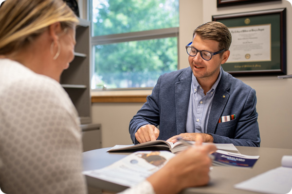two Administrators going over a pamphlet together