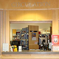 Check out items at the circulation desk