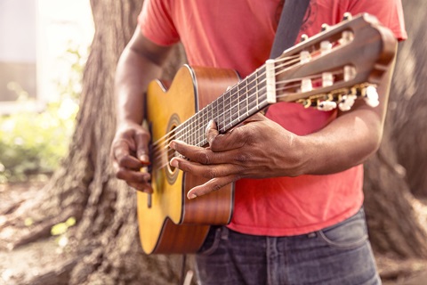 Songwriting Poetry Workshop person playing a guitar
