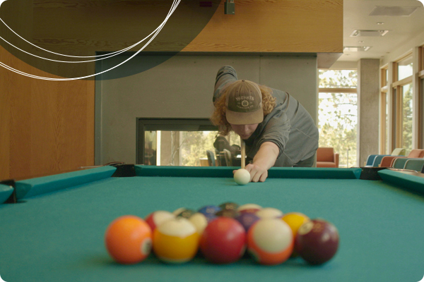 Student playing billiards, one of the amenities offered at Wickiup Hall Student playing billiards, one of the amenities offered at Wickiup Hall