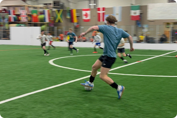 COCC Soccer Player passing the ball to a teammate