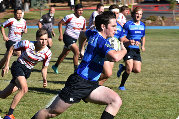 Rugby player out-maneuvering 4 opposing players