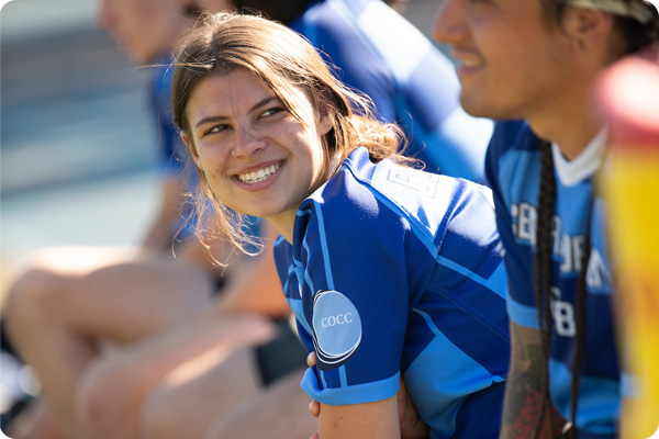 Rugby playing smiling at their teammate