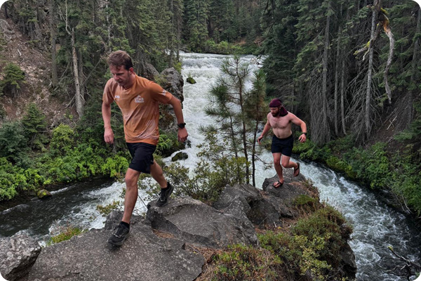 two COCC students hiking next to a river