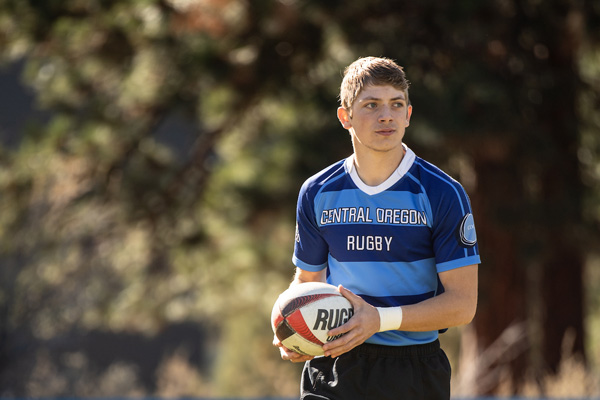 COCC Rugby player holding a rugby ball