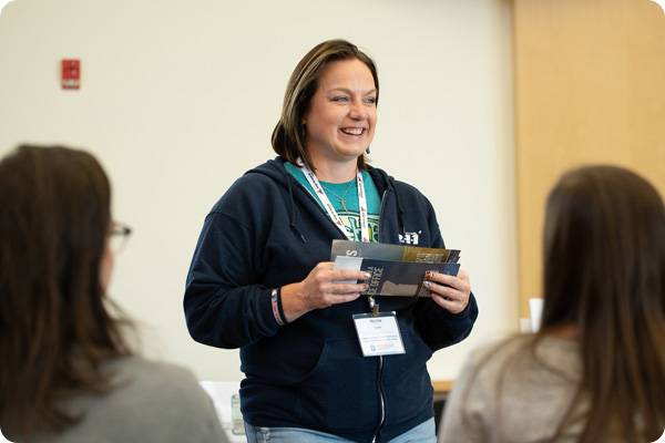 Student picking up a brochure about health benefits from Dept. of Veterans Affairs