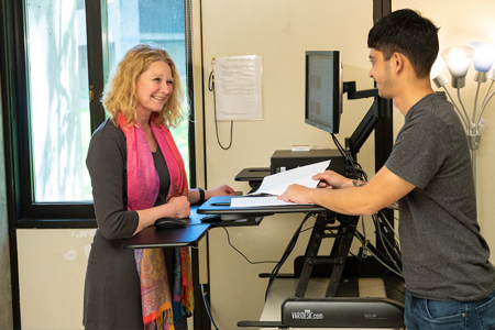 COCC Addiction Counseling and Behavioral Health faulty revieiwing a paper with a student