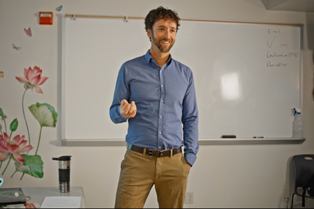 Psychology Faculty Member Teaching In Front of a White Board