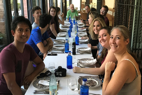 group of COCC students share a meal in a restaurant